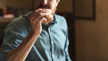 Man eating a burger aggressively
